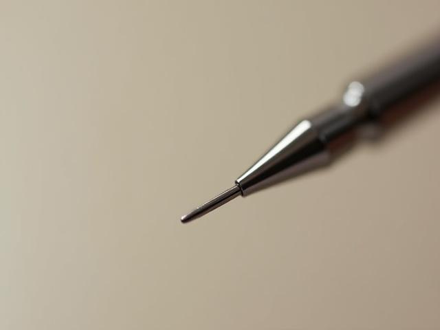 Macro shot of a single tattoo needle, sharp and gleaming